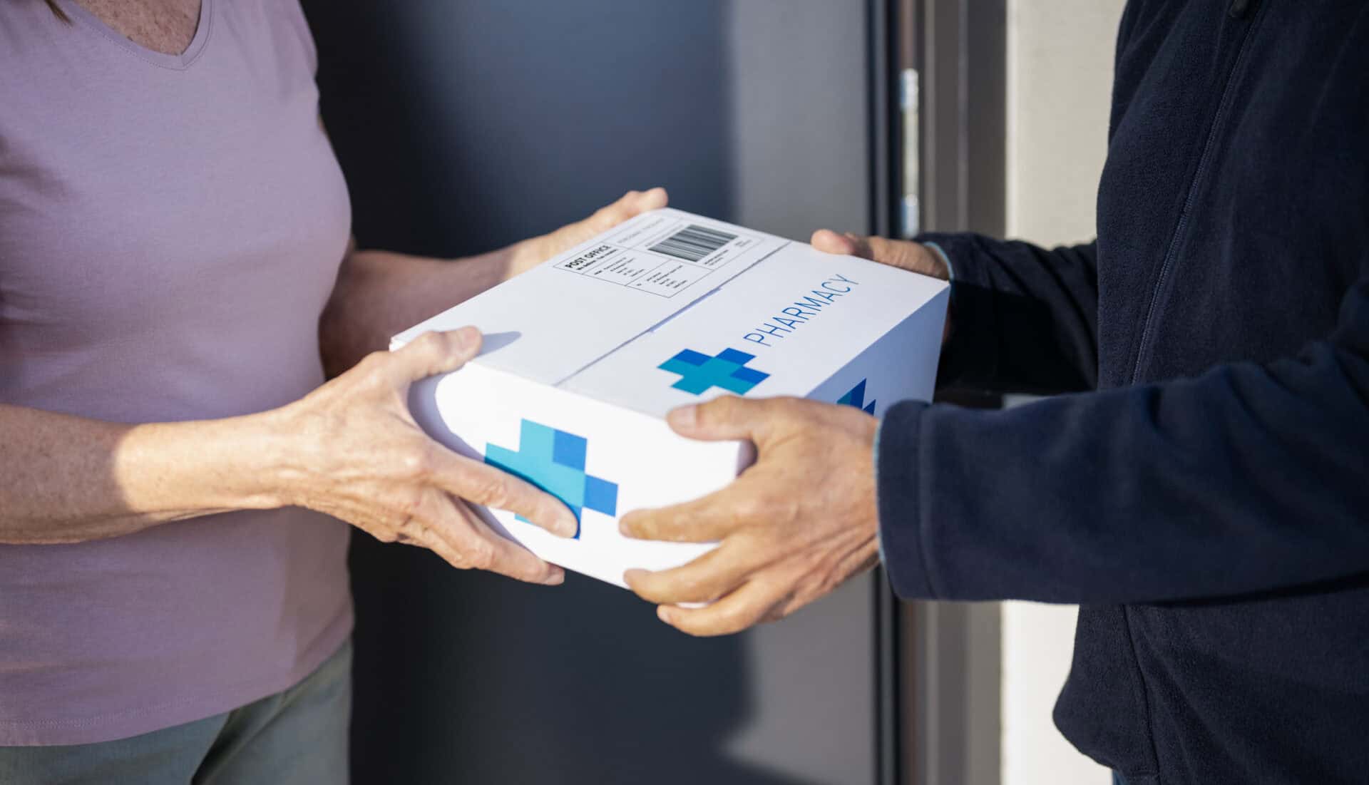 A courier delivery rider handing a package to the customer.